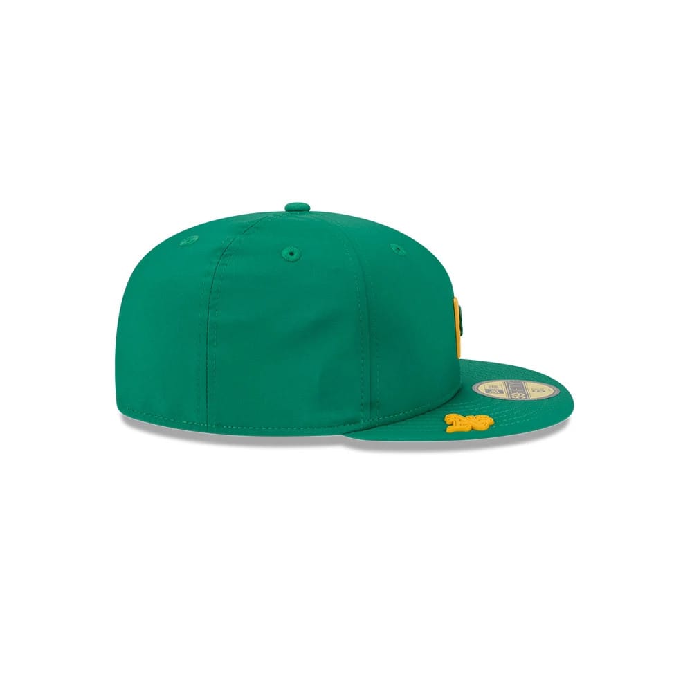 Athletics MLB Clubhouse Dark Green New Era 59FIFTY Fitted Cap, side view showing a structured dark green crown with a flat dark green visor, New Era flag logo in yellow on the left side and a gold 59FIFTY size sticker on the visor.