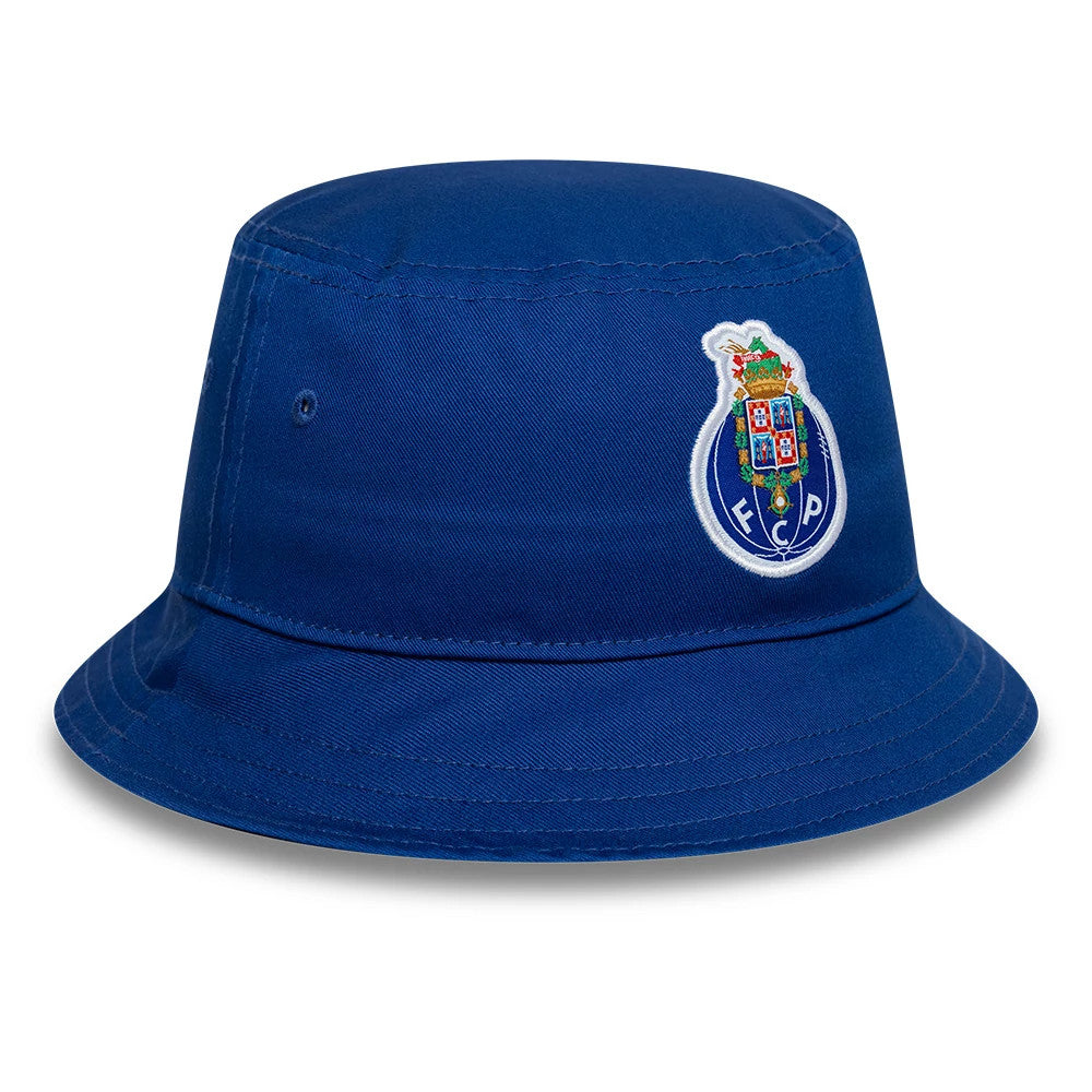 New Era FC Porto Core Blue Tapered Bucket Hat, front view showing the embroidered FC Porto crest on the structured blue crown with matching blue eyelets and a downward-sloping visor.
