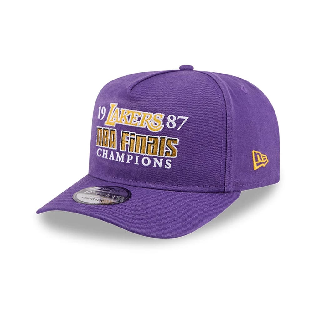LA Lakers NBA Historic Purple New Era 9FIFTY A-Frame Snapback Adjustable Cap, three-quarter view showing white and gold NBA Finals Champions embroidery on the front panel, purple visor with 9FIFTY size sticker.