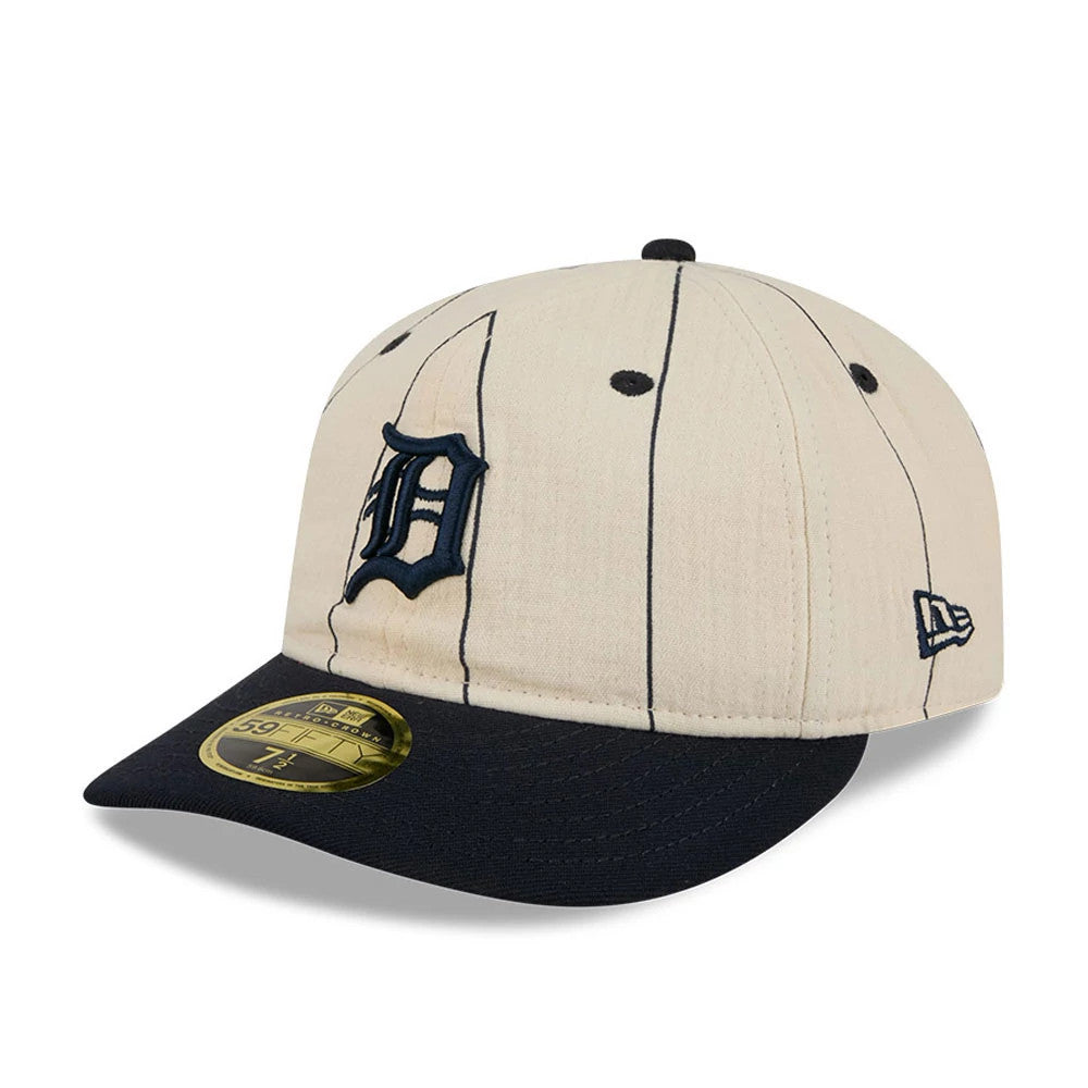Detroit Tigers MLB Linen Cream Retro Crown New Era 59FIFTY Fitted Cap, three-quarter view showing the navy embroidered front logo, navy visor, size sticker on the visor, and New Era flag logo on the left side.