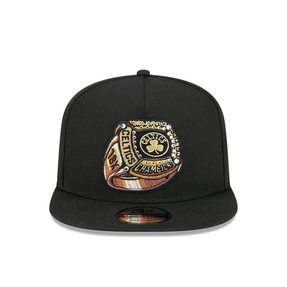 Boston Celtics NBA Ring Black New Era 9FIFTY A-Frame Snapback Adjustable Cap, front view showing a gold and brown embroidered championship ring graphic on the front panel with a flat black visor and a 9FIFTY size sticker underneath.