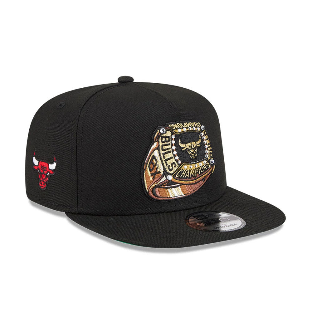 Chicago Bulls NBA Ring Black New Era 9FIFTY A-Frame Snapback Adjustable Cap, three-quarter view showing a gold and black embroidered championship ring logo on the front panel, with a black flat visor and silver 9FIFTY size sticker.
