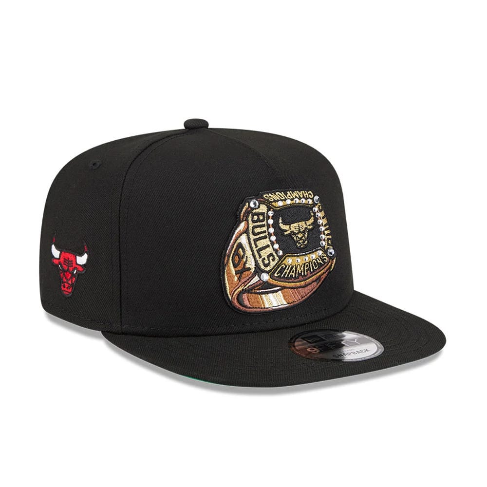 Chicago Bulls NBA Ring Black New Era 9FIFTY A-Frame Snapback Adjustable Cap, three-quarter view showing a gold and black embroidered championship ring logo on the front panel, with a black flat visor and silver 9FIFTY size sticker.