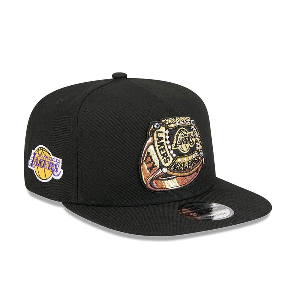 LA Lakers NBA Ring Black New Era 9FIFTY A-Frame Snapback Adjustable Cap, three-quarter view showing a detailed championship ring graphic embroidered on the front panel, paired with a flat black visor and a 9FIFTY size sticker.