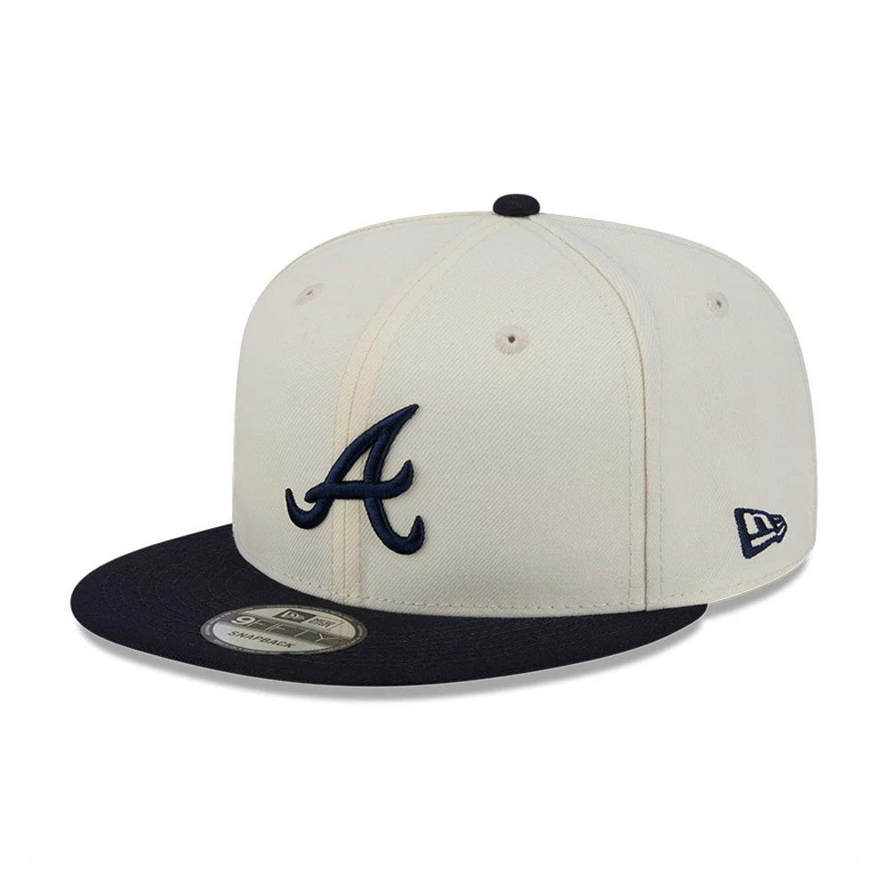 Atlanta Braves MLB Localized White New Era 9FIFTY Snapback Adjustable Cap, three-quarter view showing a navy embroidered A logo on the front panel, a black flat visor with a 9FIFTY size sticker, and the New Era flag logo on the left side.
