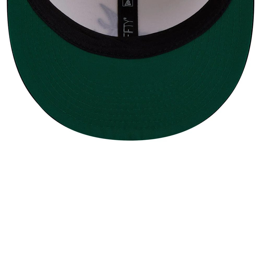 Atlanta Braves MLB Localized White New Era 9FIFTY Snapback Adjustable Cap, inside view showing the green undervisor, black sweatband, and black New Era branded taping across the inner crown.