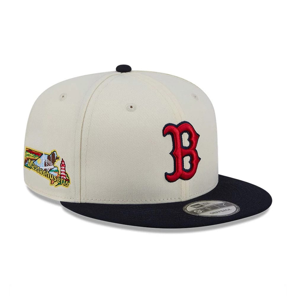 Boston Red Sox MLB Localized White New Era 9FIFTY Snapback Adjustable Cap, three-quarter view showing the raised red B embroidery on the front panel, Massachusetts graphic on the side, and black flat visor with a 9FIFTY size sticker.