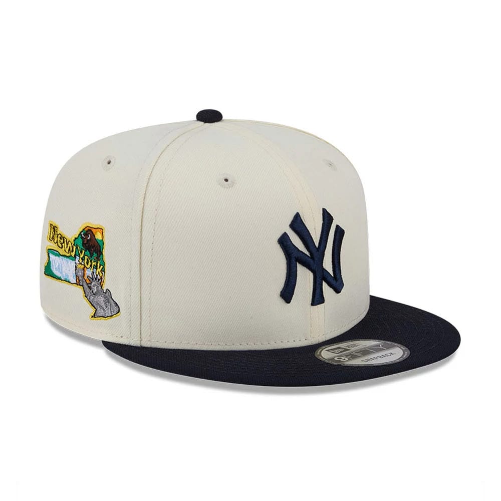 New York Yankees MLB Localized White New Era 9FIFTY Snapback Adjustable Cap, three-quarter view showing the navy embroidered Yankees logo on the front panel and an embroidered New York state graphic on the side, with a flat navy visor.