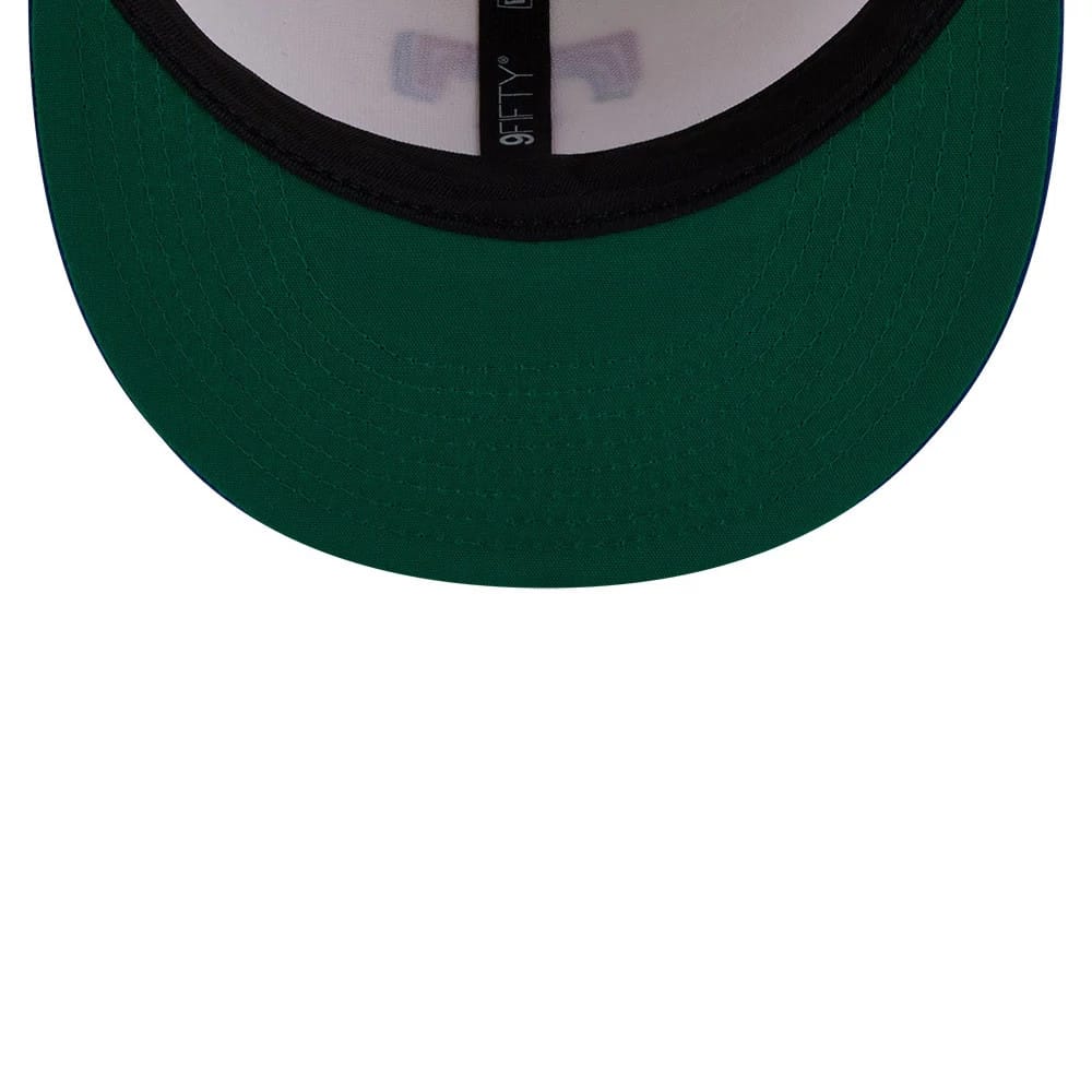Texas Rangers MLB Localized White New Era 9FIFTY Snapback Adjustable Cap, inside view showing a green undervisor, black taping featuring the 9FIFTY logo, and a white sweatband encircling the cap's interior.