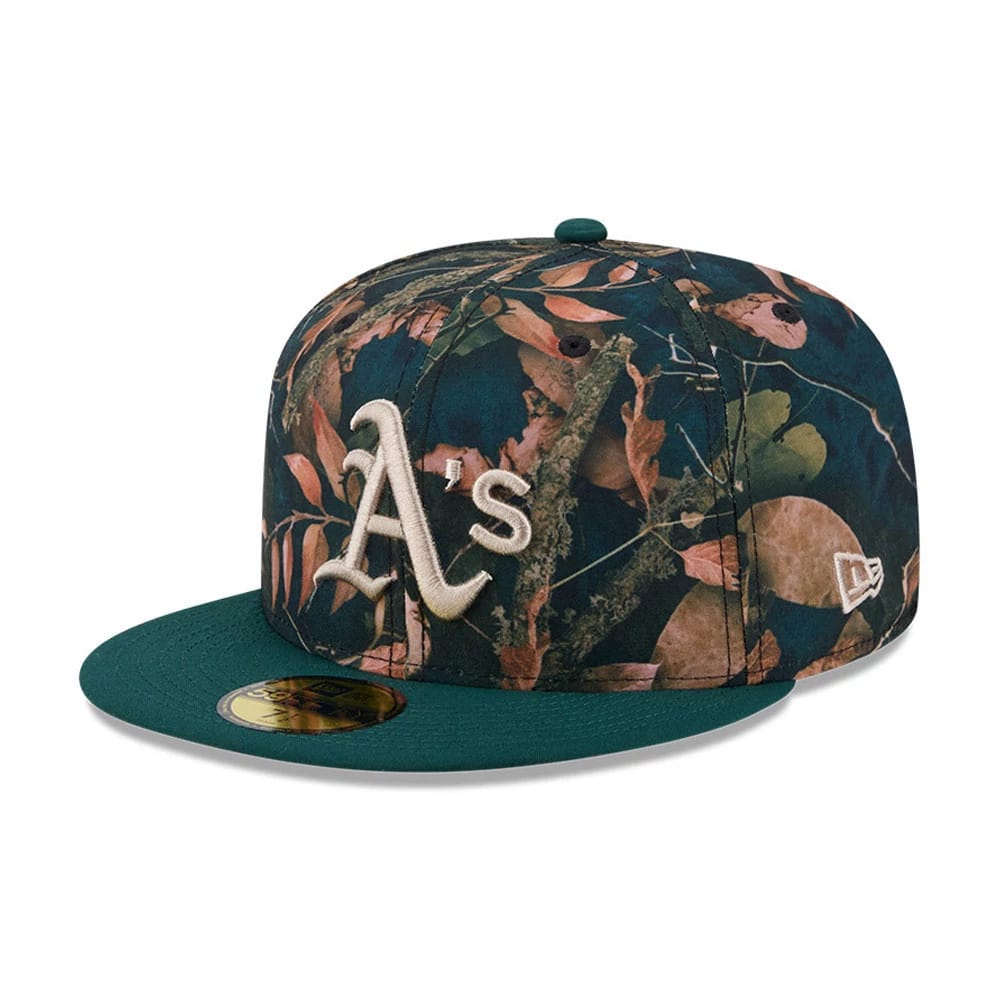Athletics MLB Leaves Dark Green New Era 59FIFTY Fitted Cap, front view showing the raised white embroidered A's logo on the structured leaves-patterned crown, with a dark green flat visor and gold 59FIFTY size sticker.