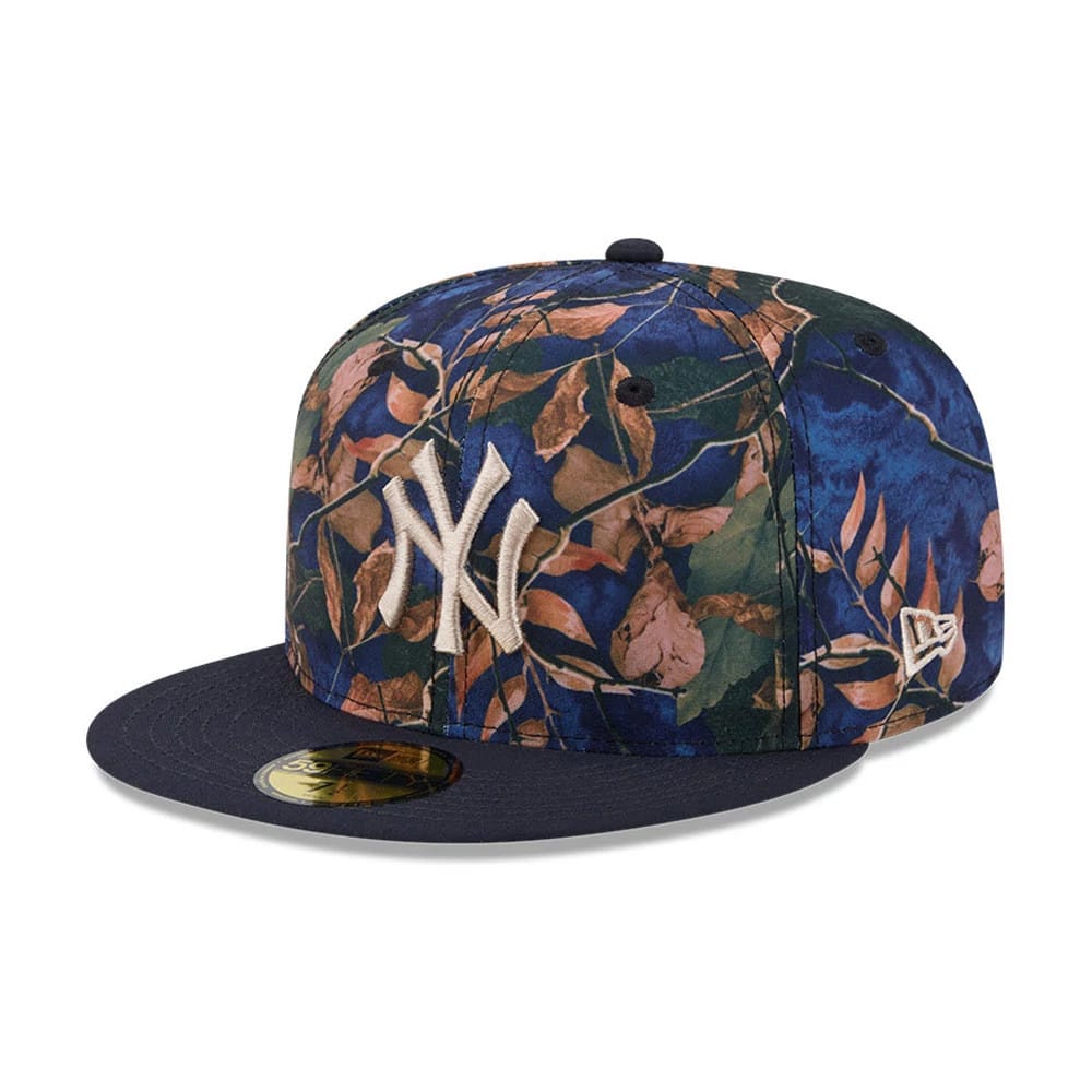 New York Yankees MLB Leaves Navy New Era 59FIFTY Fitted Cap, front view showing the raised white NY logo embroidered on a multicolour leaf-patterned crown, with a navy flat visor and gold 59FIFTY size sticker.
