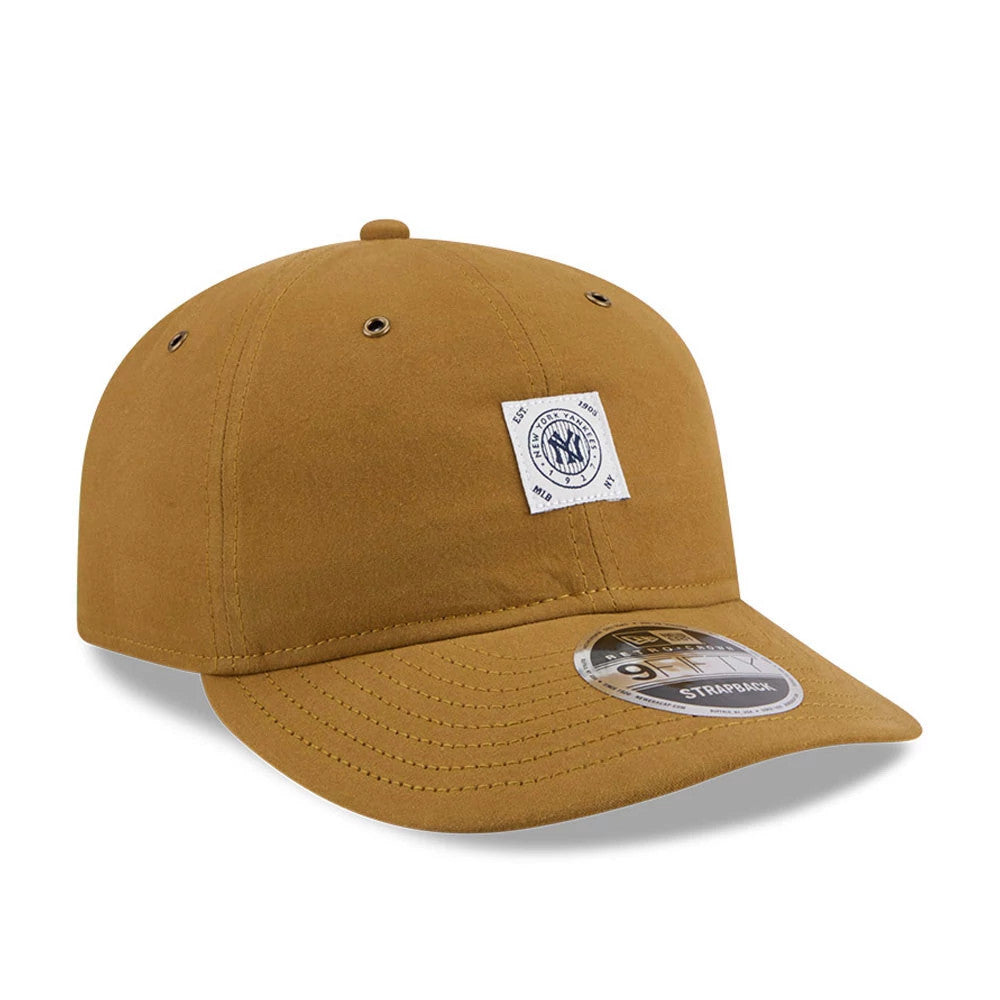 New York Yankees MLB Brushed Dark Beige Retro Crown New Era 9FIFTY Adjustable Cap, three-quarter view showing a square New York Yankees front panel patch, a matching curved visor with a 9FIFTY size sticker, and eyelets.