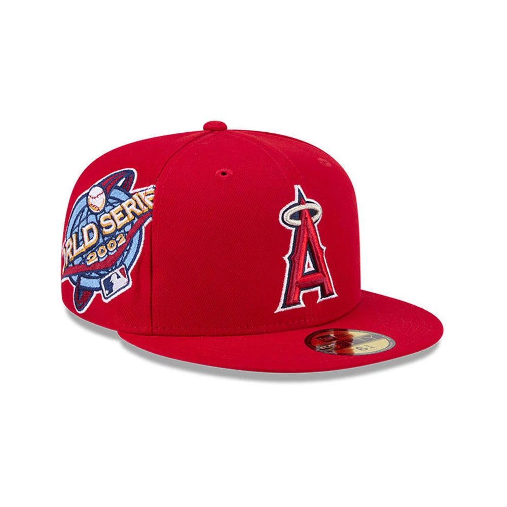 LA Angels MLB Hidden Hit Red New Era 59FIFTY Fitted Cap, three-quarter view with a red raised embroidered Angels logo on the front panel, blue and gold MLB World Series 2002 logo on the side, and a gold 59FIFTY size sticker on the red visor.