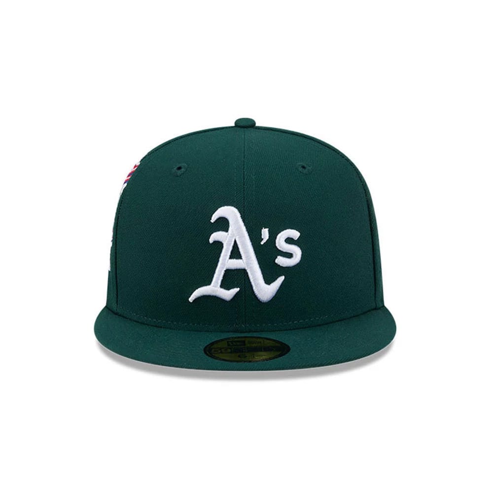Athletics MLB Hidden Hit Dark Green New Era 59FIFTY Fitted Cap, front view showing a raised white embroidered A's logo on the structured dark green crown, complemented by a flat visor with a gold 59FIFTY size sticker.