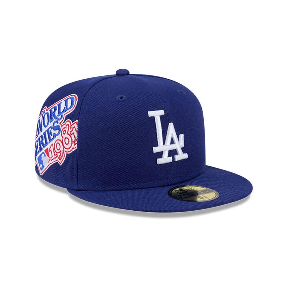 LA Dodgers MLB Hidden Hit Dark Blue New Era 59FIFTY Fitted Cap, three-quarter view showing the white raised LA logo on the front panel, World Series 1988 embroidery on the side, and a gold 59FIFTY size sticker on the flat dark blue visor.