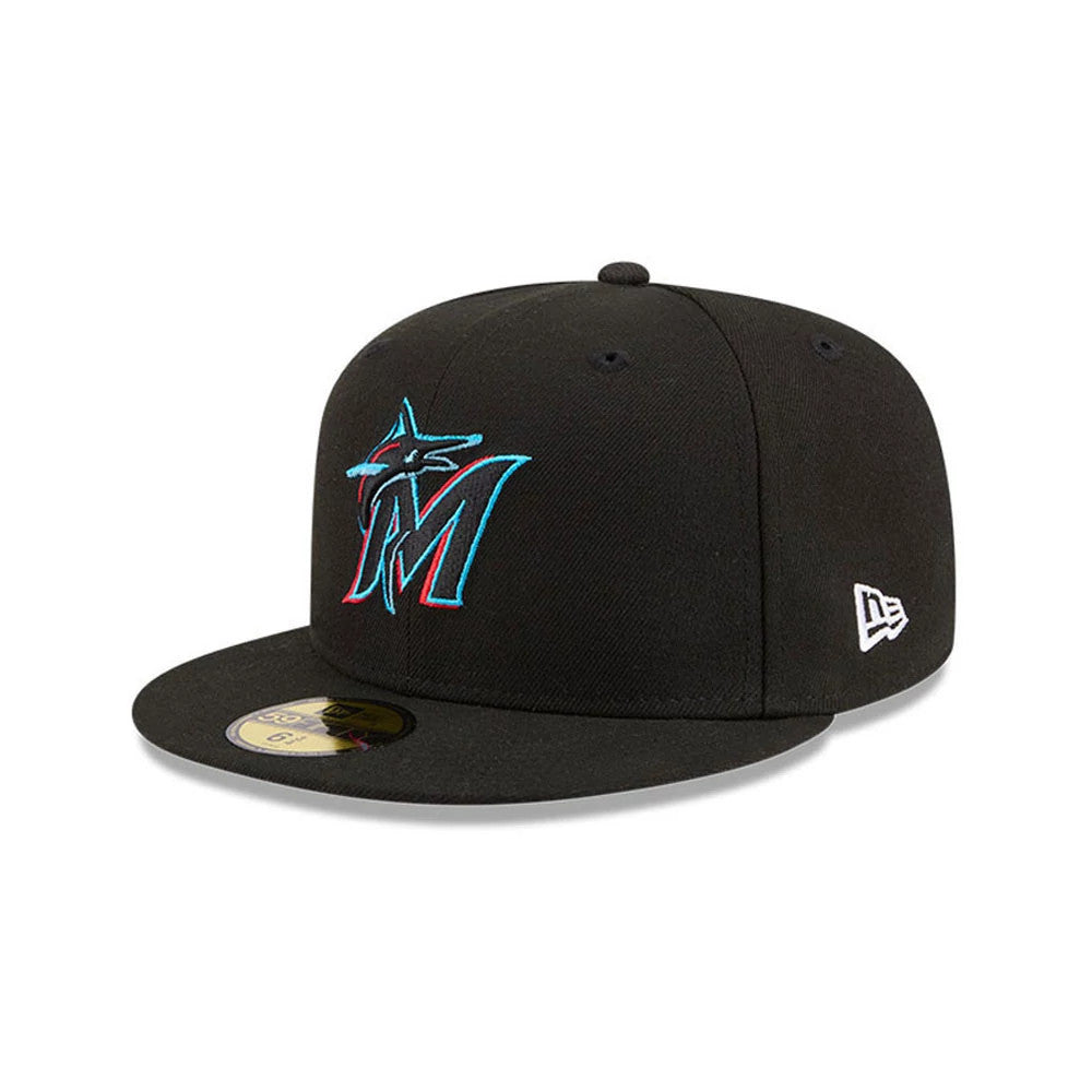 Miami Marlins MLB Hidden Hit Black New Era 59FIFTY Fitted Cap, three-quarter view showing the turquoise and red embroidered Marlins logo on the front panel, black visor with a gold 59FIFTY size sticker, and New Era flag logo on the left side.