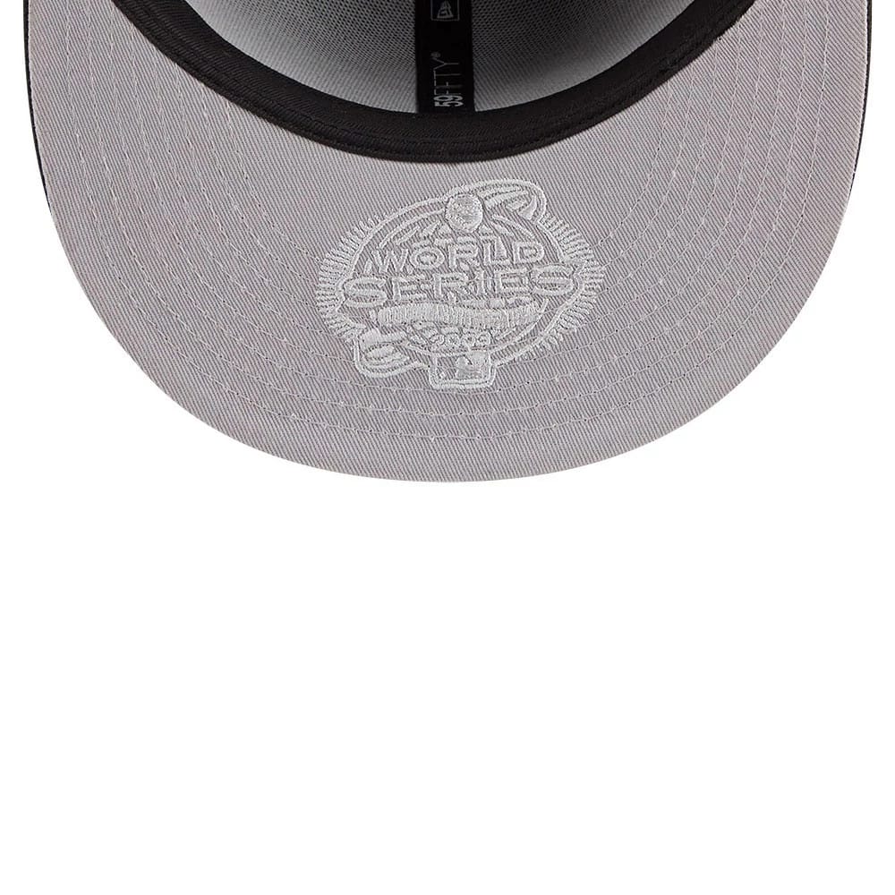 Miami Marlins MLB Hidden Hit Black New Era 59FIFTY Fitted Cap, inside view showing the grey undervisor with an embroidered white World Series graphic, black sweatband, and brand taping along the seams.