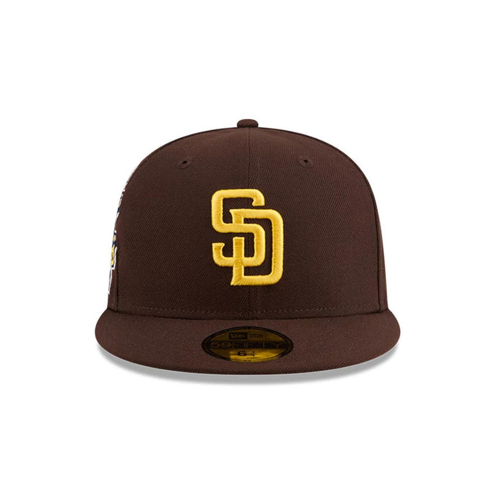 San Diego Padres MLB Hidden Hit Dark Brown New Era 59FIFTY Fitted Cap, front view showing the raised gold SD logo embroidered on the structured dark brown crown, with a flat visor and gold 59FIFTY size sticker.