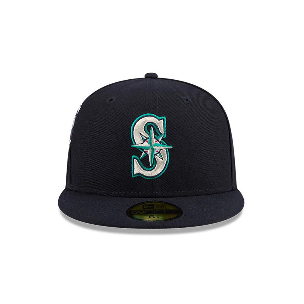 Seattle Mariners MLB Hidden Hit Navy New Era 59FIFTY Fitted Cap, front view showing the raised teal and white embroidered S logo with a compass star on the front panel, and a gold 59FIFTY size sticker on the flat navy visor.