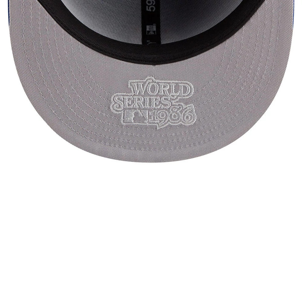 New York Mets MLB Hidden Hit Blue New Era 59FIFTY Fitted Cap, inside view showing the black sweatband, grey undervisor with white embroidered World Series 1986 logo, and part of the MLB Batterman logo on the taping.