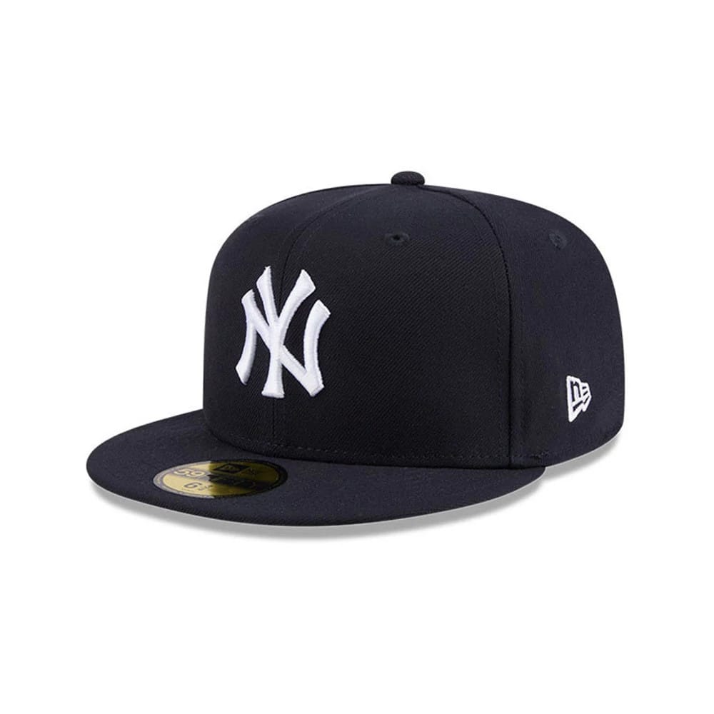 New York Yankees MLB Hidden Hit Navy New Era 59FIFTY Fitted Cap, three-quarter view showing the raised white NY logo on the front panel, navy flat visor with gold 59FIFTY size sticker, and New Era flag logo on the left side.