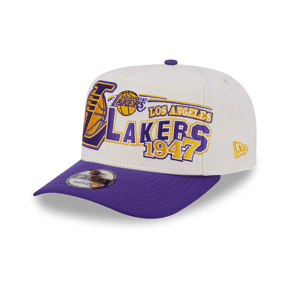 LA Lakers NBA Classic White New Era 9FIFTY A-Frame Snapback Adjustable Cap, three-quarter view featuring a raised embroidered LA Lakers logo in purple and gold on the front panels, with a contrasting purple visor.