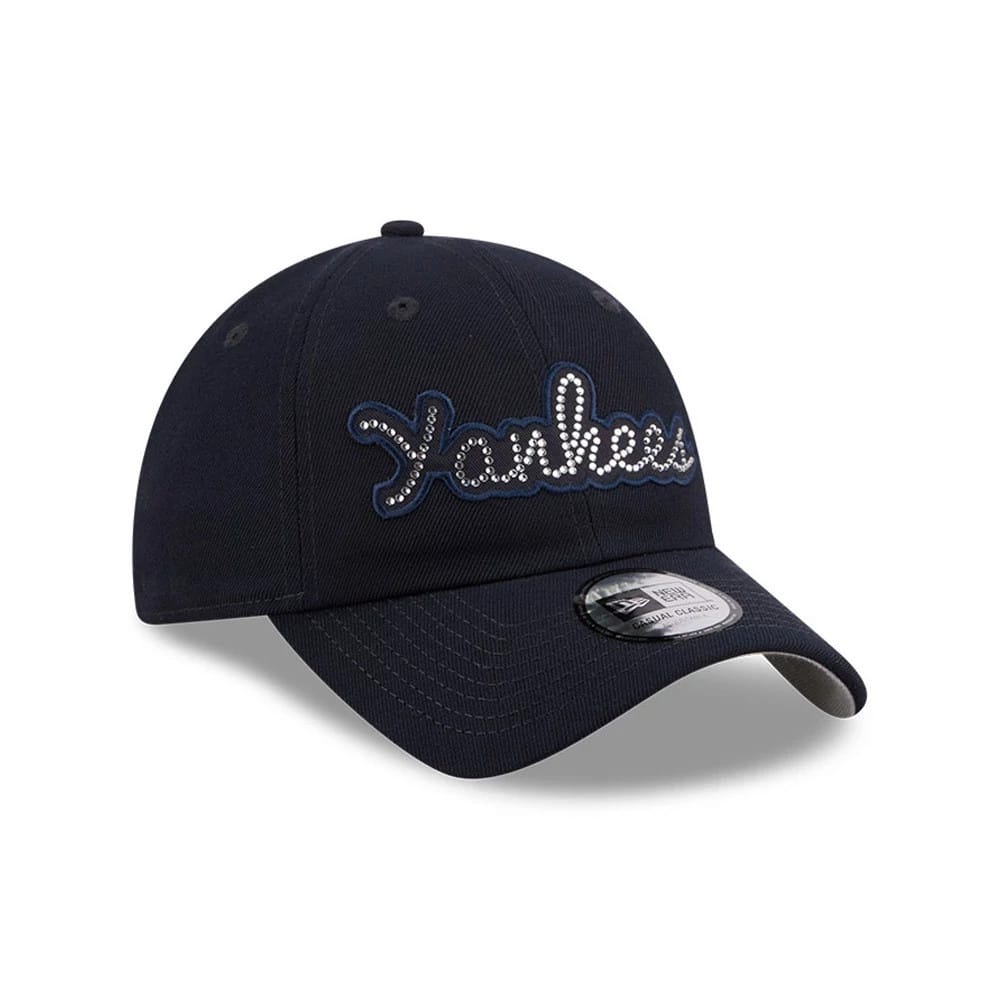 New Era New York Yankees MLB Rhinestone Navy Casual Classic Adjustable Cap, three-quarter view showing the Yankees script in rhinestones on the front panel, with a curved visor and a New Era logo on the left side.