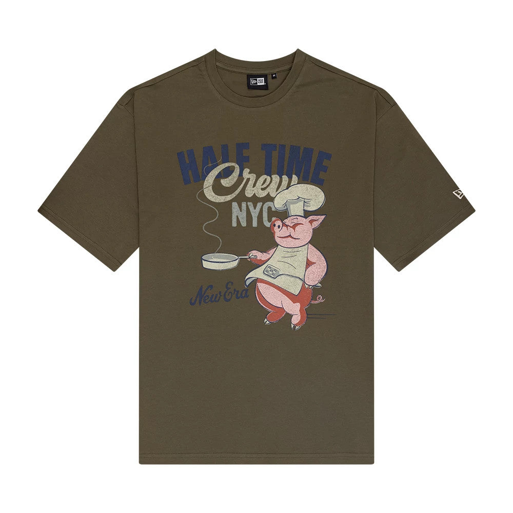 New Era Food Graphic Green Oversized T-Shirt, front view displaying a playful pig chef graphic holding a frying pan with 'HALF TIME Crew NYC' lettering above, an embroidered New Era logo on the left sleeve and the phrase on the bottom.