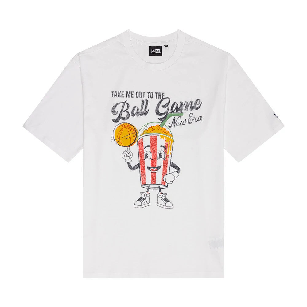 New Era Soda Graphic White Oversized T-Shirt, front view featuring a colourful cartoon popcorn character holding a basketball, with Take Me Out To The Ball Game printed above in playful black lettering and a printed New Era logo alongside.
