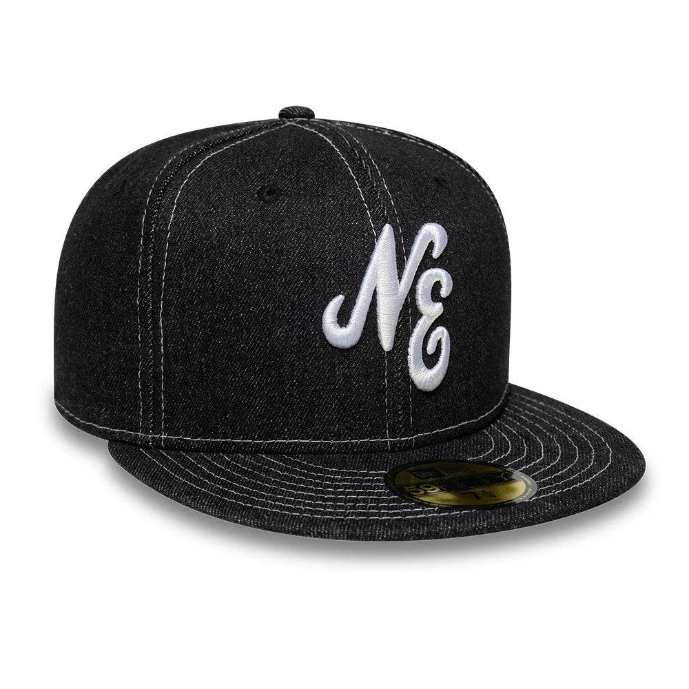 New Era Denim Black 59FIFTY Fitted Cap, three-quarter view showing a raised white NE logo embroidered on the front panel, with a flat black visor, gold 59FIFTY size sticker, and white contrast stitching throughout.