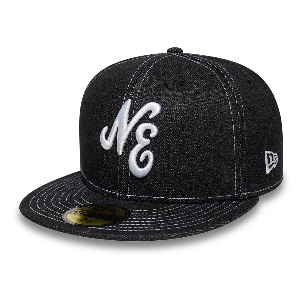 New Era Denim Black 59FIFTY Fitted Cap, three-quarter view showing white raised embroidery NE on the front panel, a flat black denim visor with white stitching, and a gold 59FIFTY size sticker, plus the New Era flag logo on the left side.