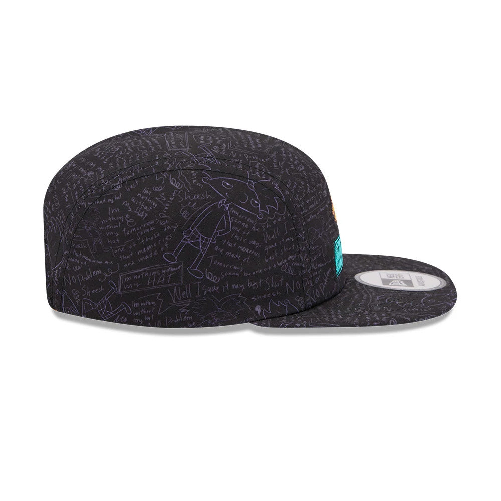 New Era Hey Arnold All Over Print Black Camper Cap, side view with a flat black visor and intricate white doodle graphics, featuring a bright teal New Era flag logo on the left side of the structured crown.