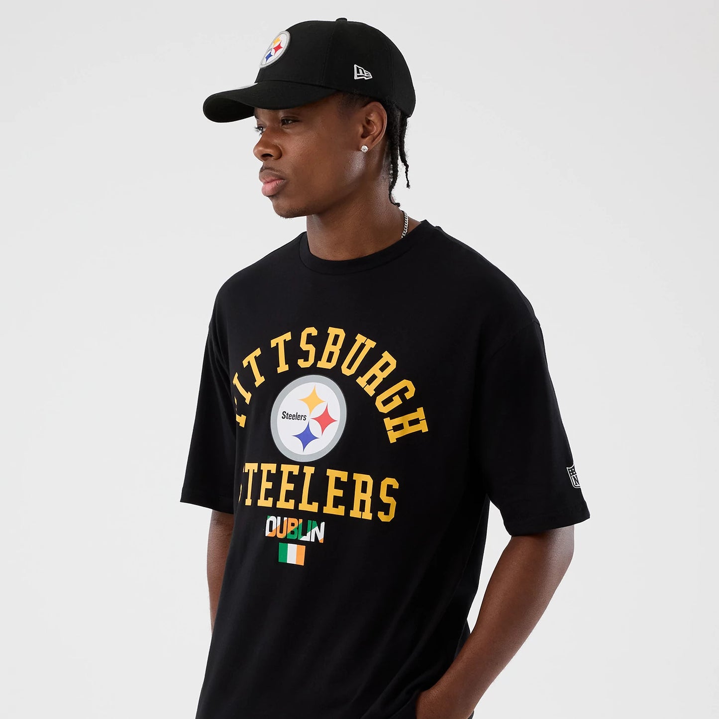 The Male model is wearing Pittsburgh Steelers NFL International Series Games Black Oversized T-Shirt 7