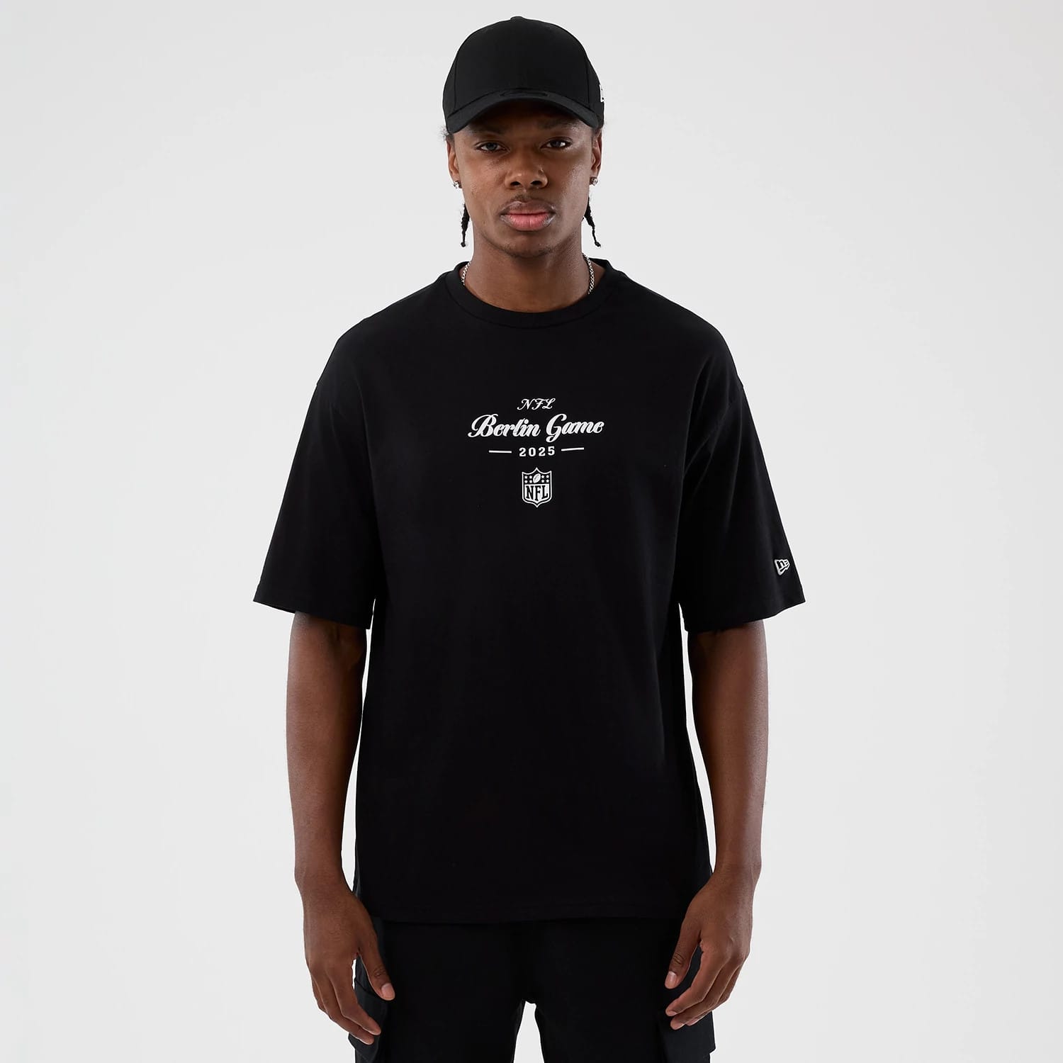 The Male model is wearing Berlin NFL International Series Games Black Oversized T-Shirt 1