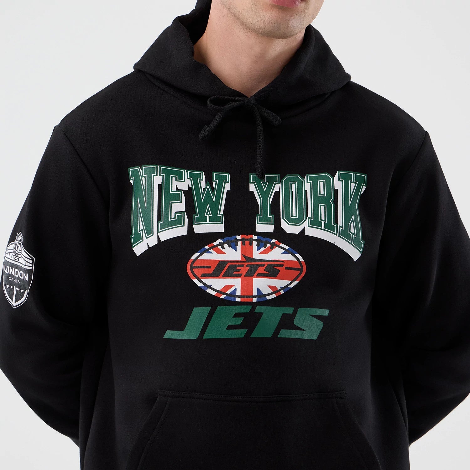 New Era New York Jets NFL International Series Games Black Pullover Hoodie, front view showing New York Jets lettering and Union Jack with an American football graphic on chest, and London Games patch on the left sleeve.