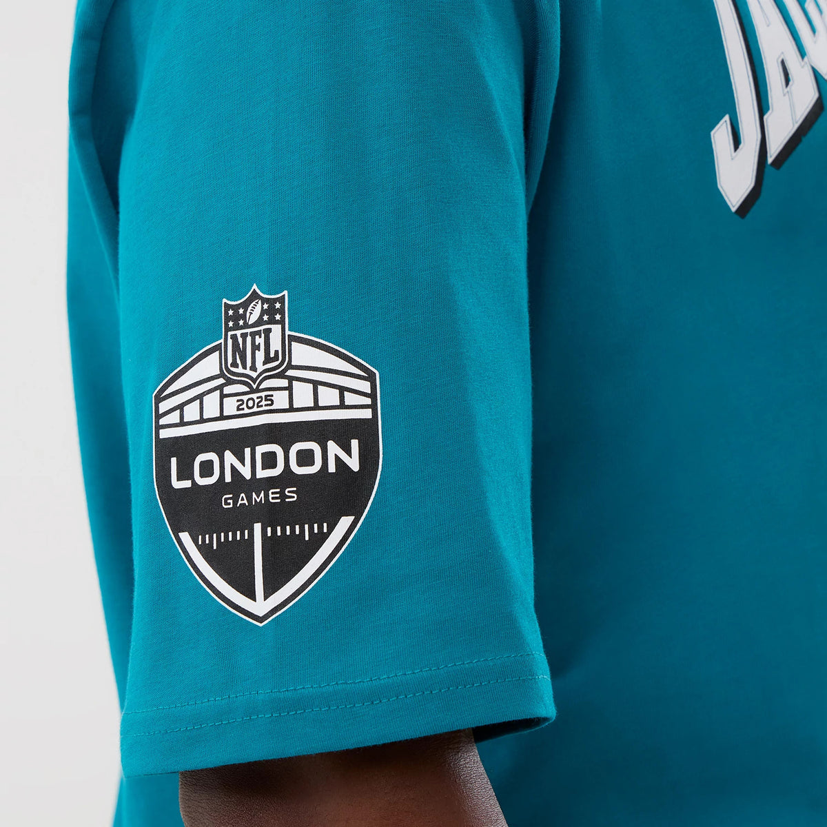 New Era Jacksonville Jaguars NFL International Series Games Turquoise Oversized T-Shirt, side view showing the printed 2025 London Games NFL shield on the sleeve and a view of the Jaguars lettering in white on the turquoise fabric.