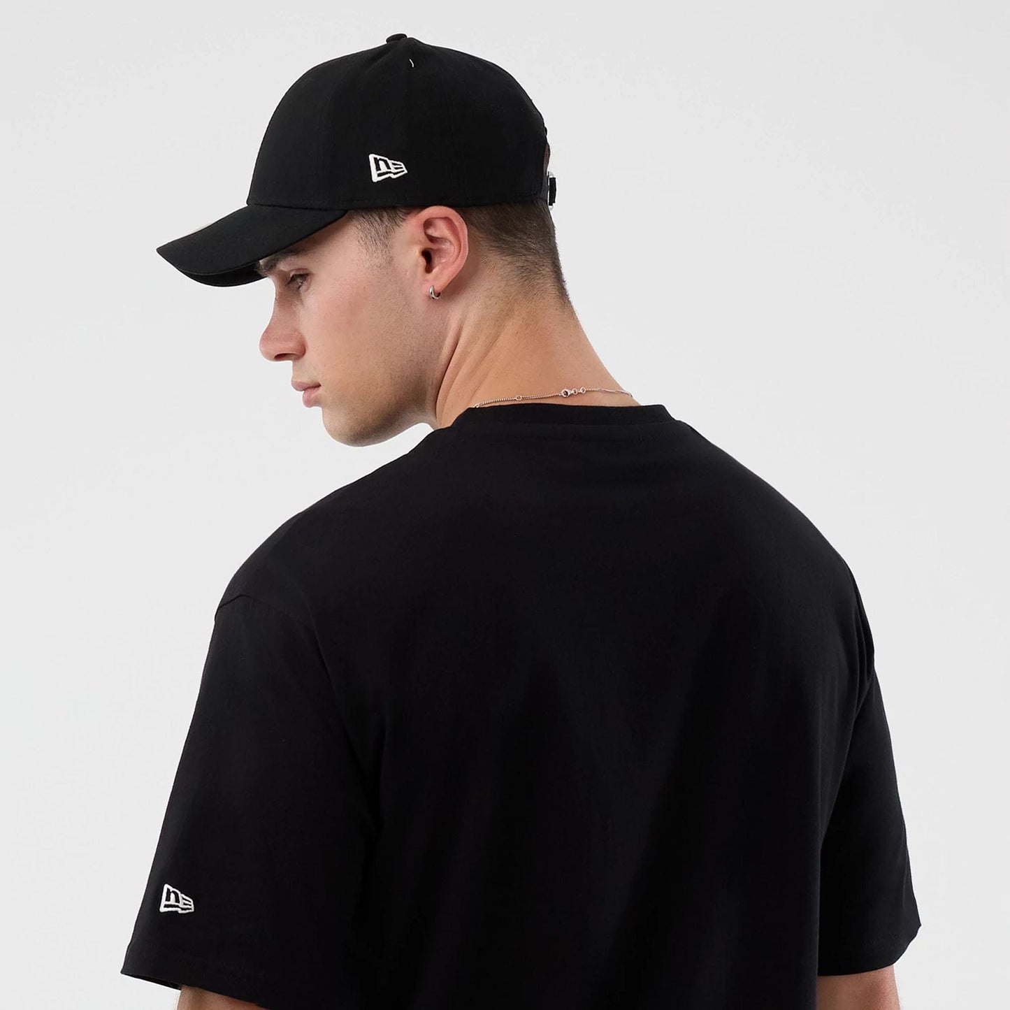 The Male model is wearing Madrid Game NFL International Series Games Black Oversized T-Shirt 7