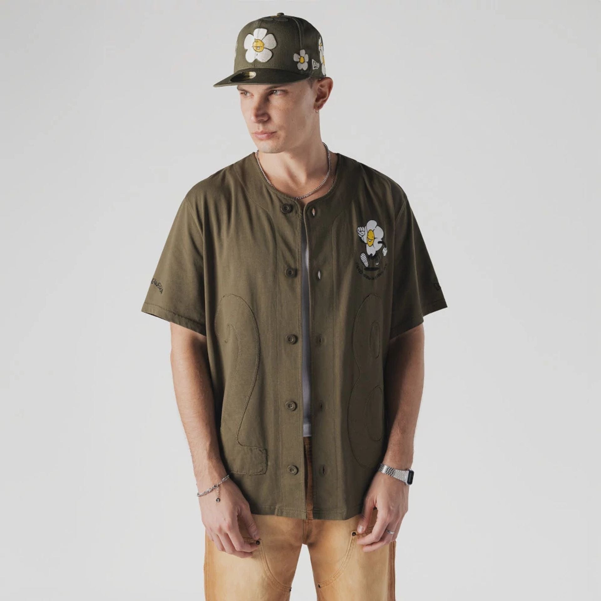 The Male model is wearing New Era x Rodrigo Roji Flower Green Jersey 1