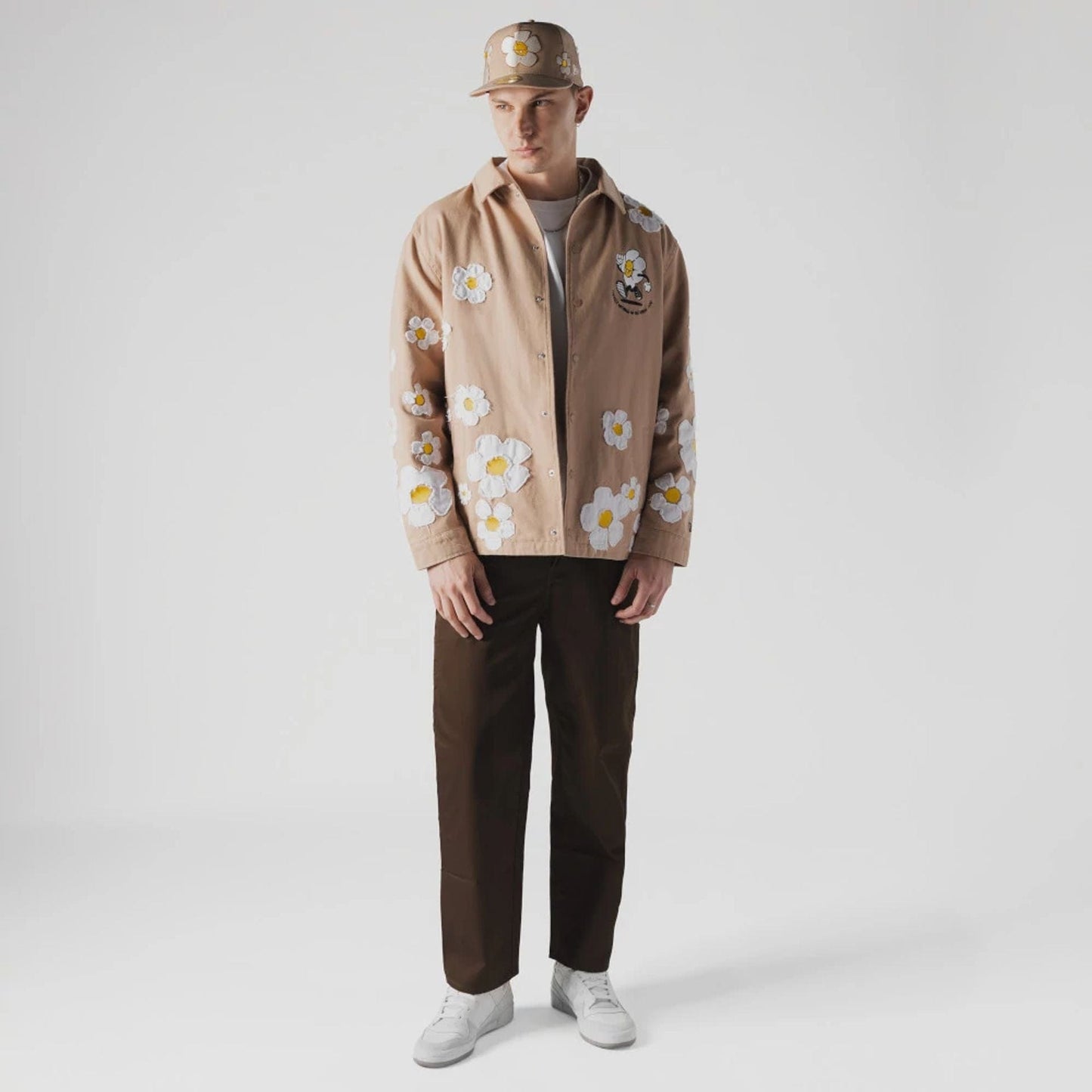 The Male model is wearing New Era x Rodrigo Roji Flower Light Beige Jacket 4