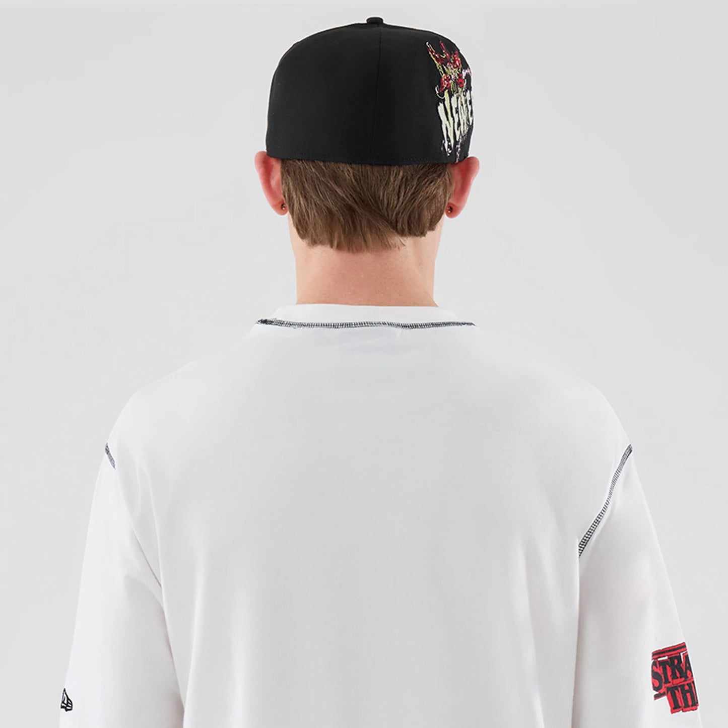 The Male model is wearing Stranger Things White Oversized T-Shirt 7