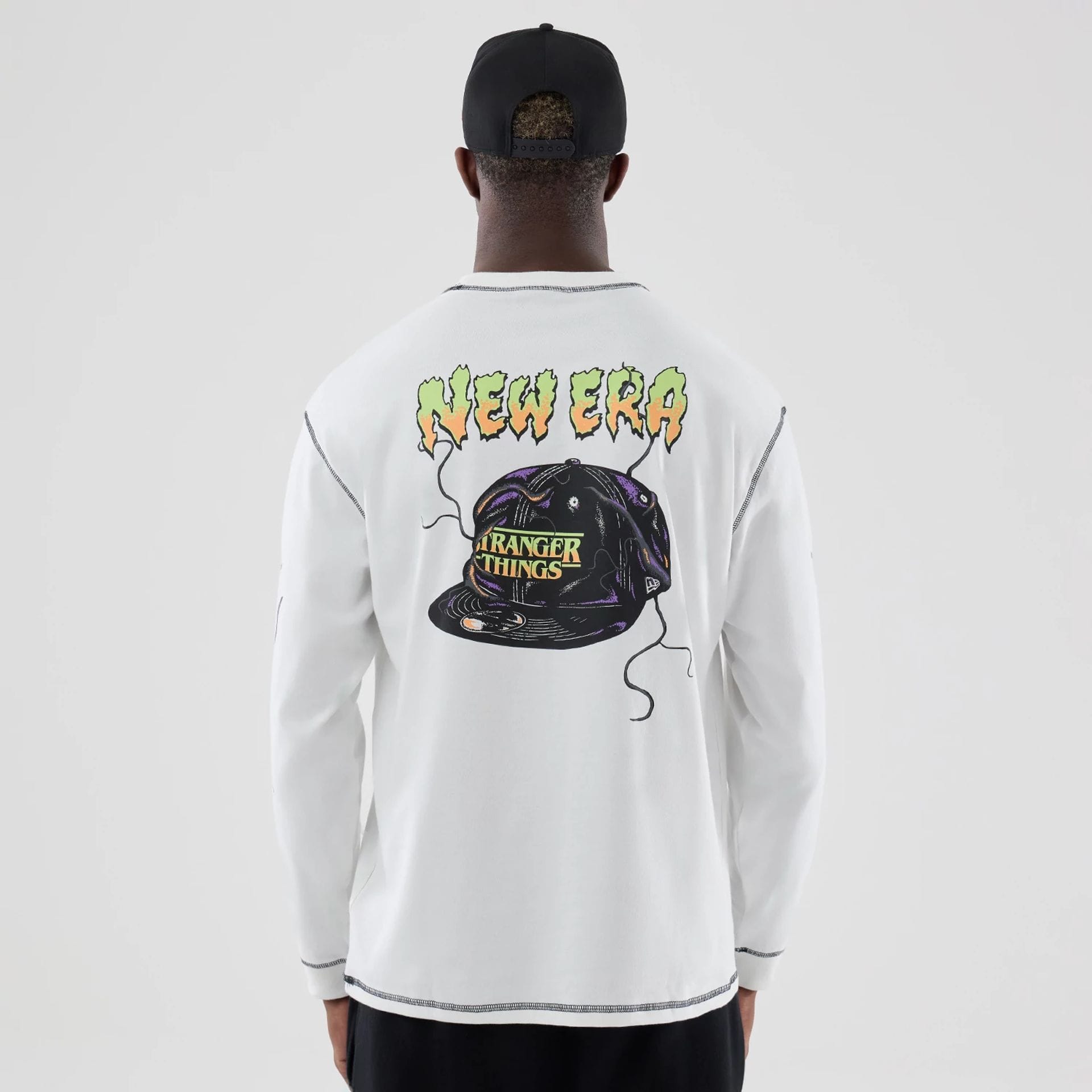 The Male model is wearing Stranger Things White Oversized Long Sleeve T-Shirt 2