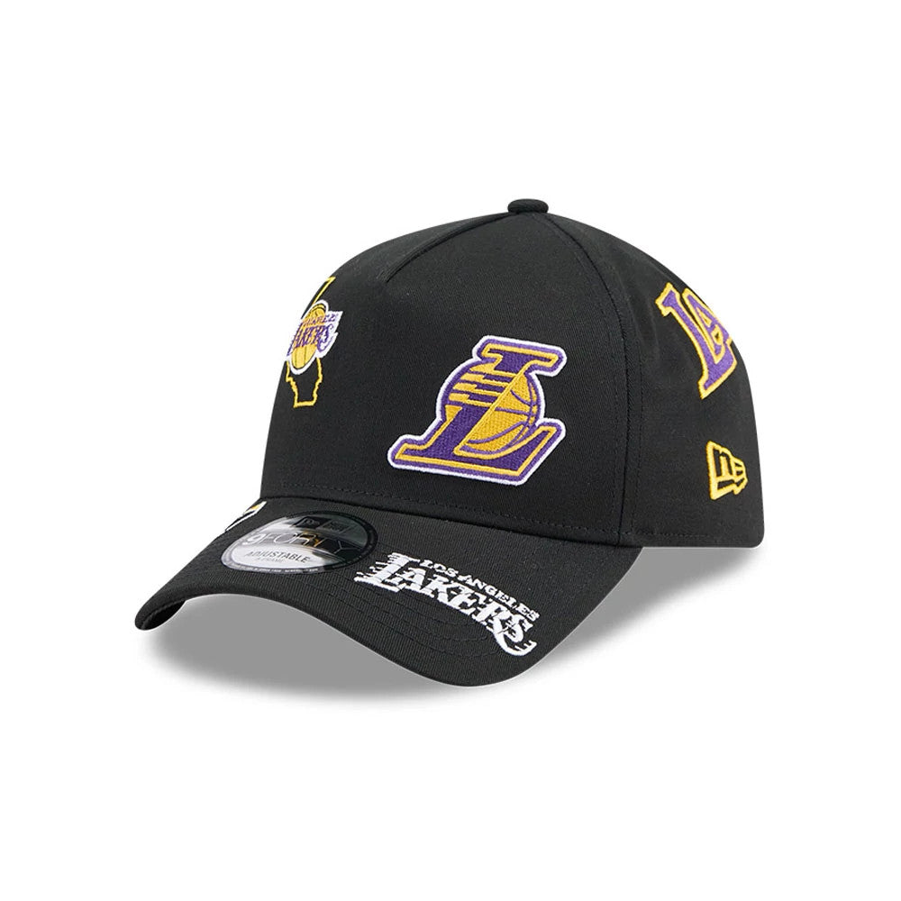 LA Lakers NBA All Over Black New Era 9FORTY A-Frame Adjustable Cap, three-quarter view showing the large embroidered Lakers logo on the front panel, with additional team logo patches and a black visor with a white Los Angeles Lakers wordmark.