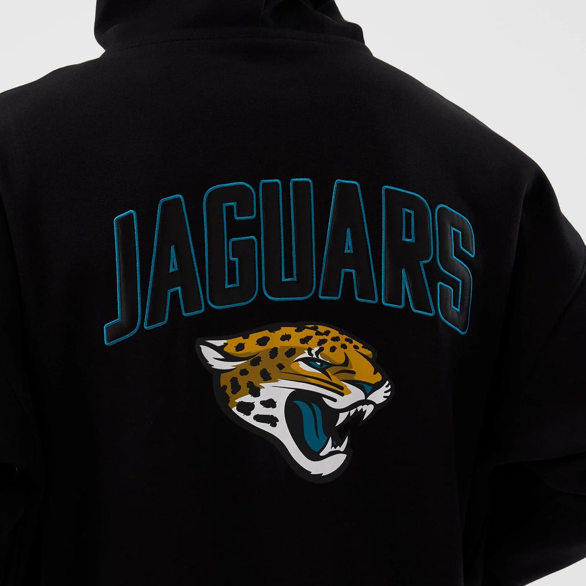 New Era Jacksonville Jaguars NFL International Series Games Black Full Zip Hoodie, back view showing large blue-outlined Jaguars lettering across the shoulder blades and a printed snarling jaguar head logo below it on the black fabric.