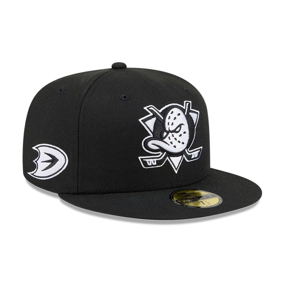 Anaheim Ducks NHL Evergreen Black New Era 59FIFTY Fitted Cap, three-quarter view showing a white and grey embroidered Ducks logo on the front panel, a matching logo on the left side, and a gold 59FIFTY size sticker on the black flat visor.