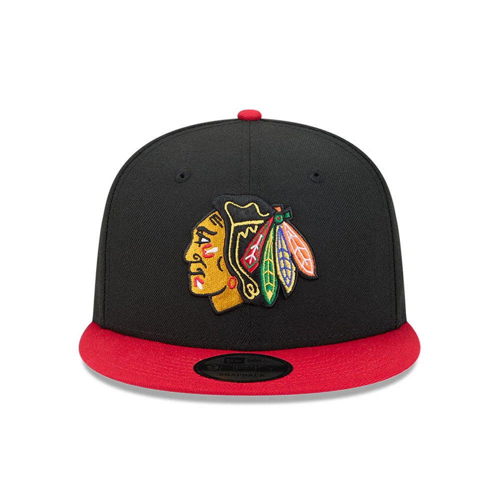 Chicago Blackhawks NHL Evergreen Black New Era 9FIFTY Snapback Adjustable Cap, front view showing the team logo embroidered in colours on the structured black crown, with a bright red visor and black 9FIFTY size sticker.