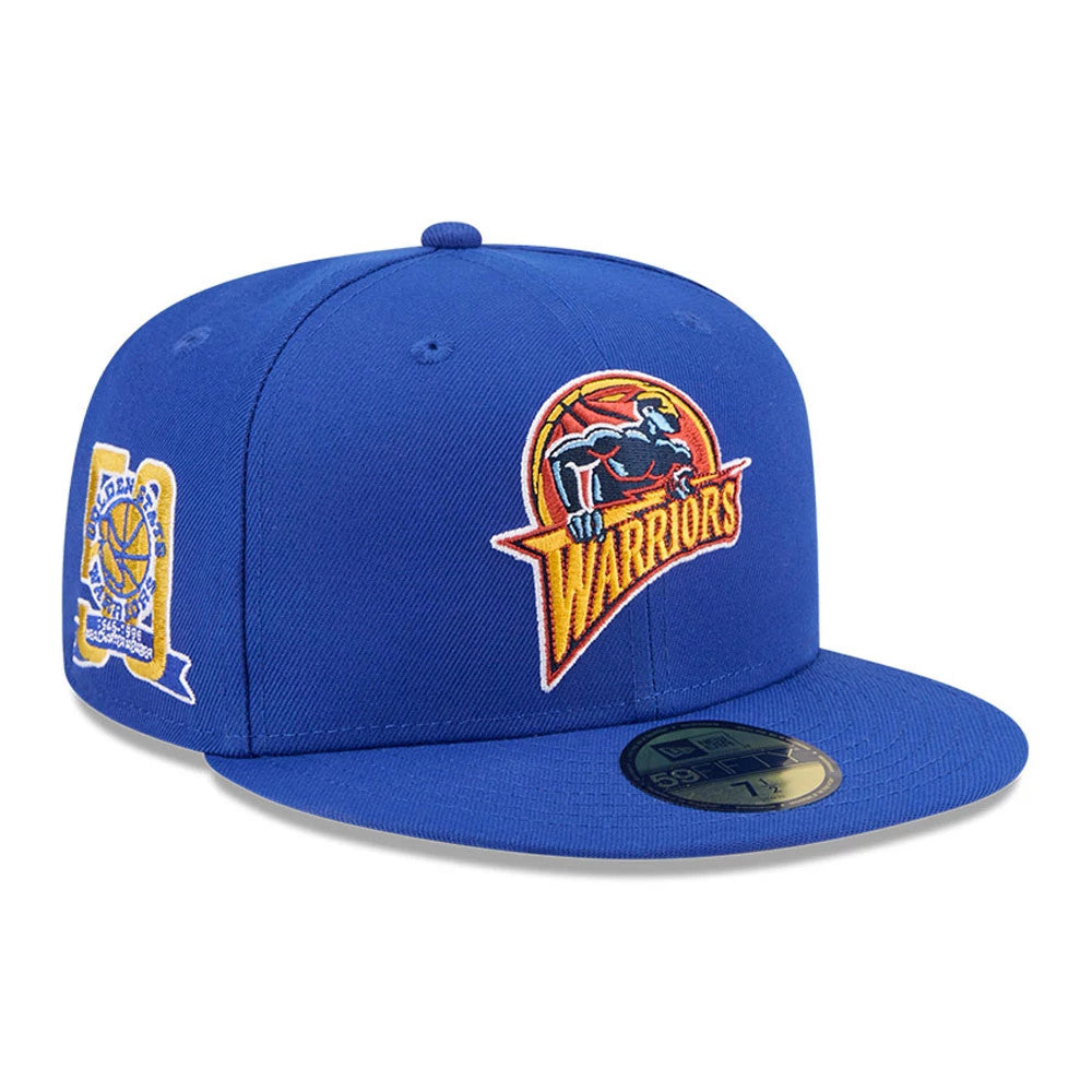 Warriors NBA Hardwood Classic Sidepatch Blue New Era 59FIFTY Fitted Cap, three-quarter view showing a raised Warriors logo embroidered on the front panel, a commemorative side patch on the right side.