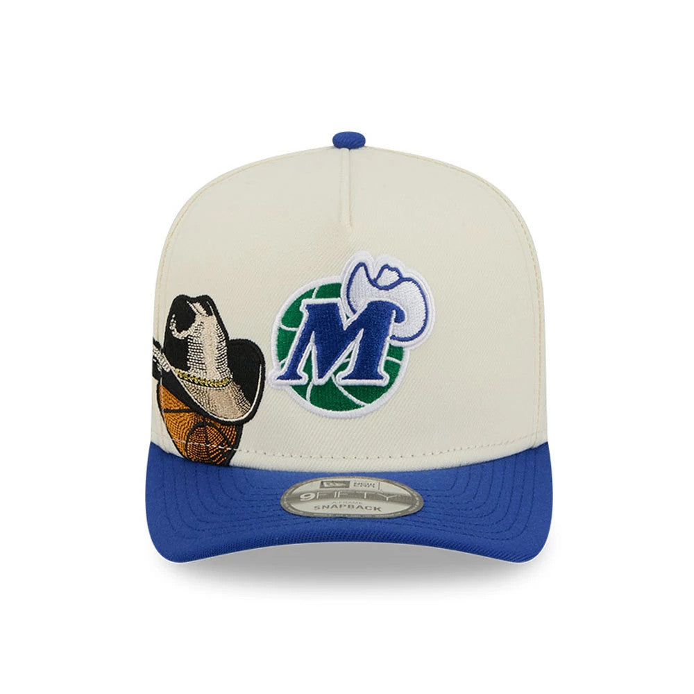 Dallas Mavericks NBA Blue New Era 9FIFTY A-Frame Snapback Adjustable Cap, front view showing a white and green embroidered M logo with a cowboy hat on the front panel, set above a blue visor and a 9FIFTY size sticker.