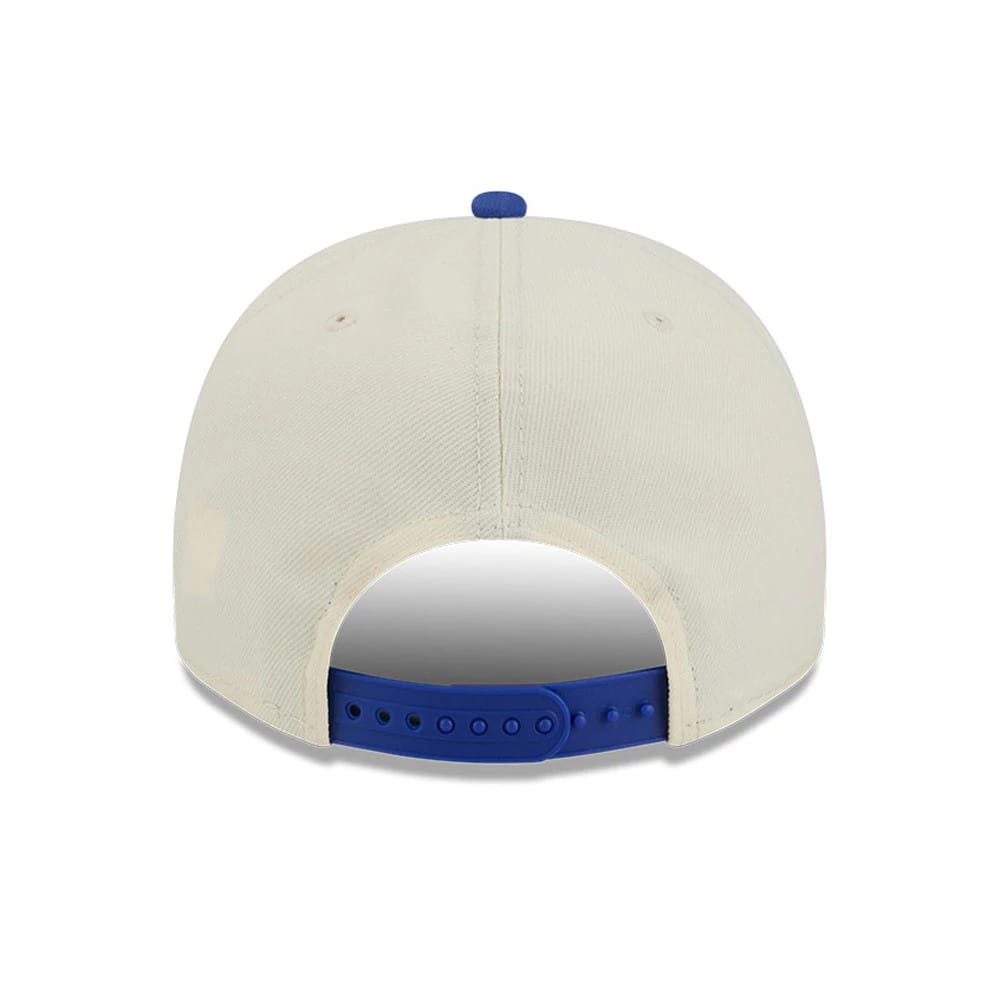 Dallas Mavericks NBA Blue New Era 9FIFTY A-Frame Snapback Adjustable Cap, rear view showing the blue plastic snap closure and matching blue top button on the cream structured crown.
