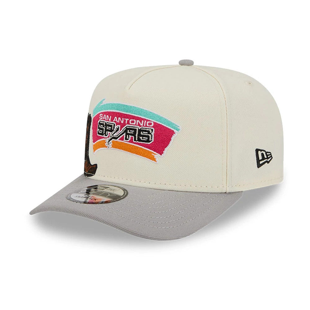 San Antonio Spurs NBA Grey New Era 9FIFTY A-Frame Snapback Adjustable Cap, three-quarter view showing multicoloured embroidered team logo on the front panel, grey visor with 9FIFTY size sticker, and New Era flag logo on the left side.