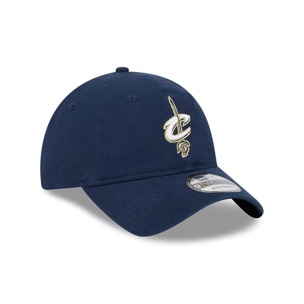Cleveland Cavaliers NBA Classic Dark Blue New Era 9TWENTY Adjustable Cap, three-quarter view showing the white and gold Cavaliers logo embroidered on the front panel, with a curved visor and 9TWENTY size sticker.